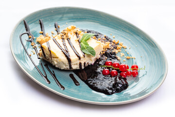 Sponge cake pieces decorated with red currants and mint