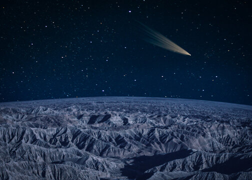Comet passing over a barren mountain landscape