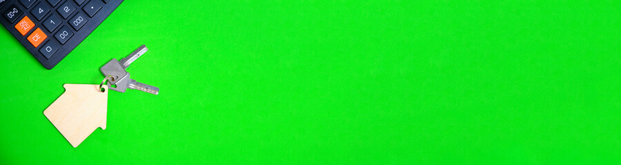 Panorama Banner Calculator House and Apartment Keys on a Green Background