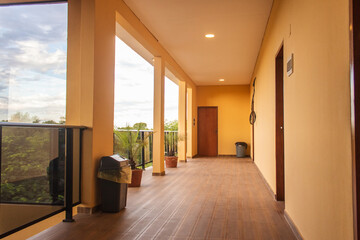 The corridor of a hotel overlooking the landscape