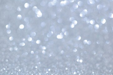 Abstract white bokeh lights glittering on blur background