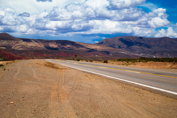 Fototapeta na wymiar Desolate landscape of a route in Latin America. Driving down the empty road to the mountain in northern Argentina