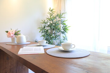 coffee and flowers on the table in a bright modern interior