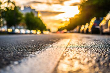 Sun after the rain in the city, view of the headlights of the approaching cars with the level dividing line © Georgii Shipin
