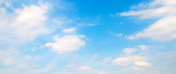 White clouds on the blue sky. Wide photo.