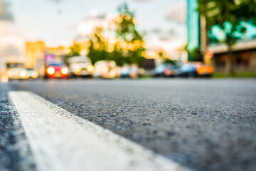Sun after the rain in the city, view of the approaching cars with the level dividing line