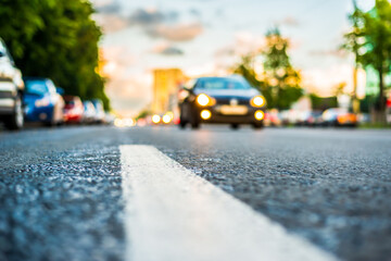Sun after the rain in the city, view of the approaching car with the level dividing line