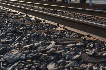 Fototapeta na wymiar Detail of train tracks, directed towards the vanishing point