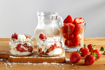 Red fresh strawberries on the kitchen table in a minimalist room 