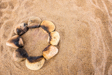 Fototapeta na wymiar Circle of stones for the bonfire on the beach