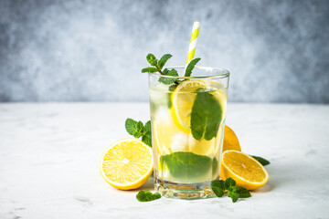 Lemonad in the glass. Traditional summer drink with lemon, mint and ice cube.