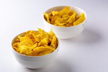 Bowls of Unripe Plantain chips Close up view © Bassey