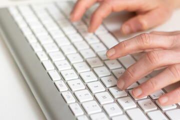 Hands typing with the computer keyboard. Business and education concept.