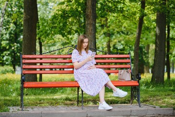 Pregnant woman resting in the park