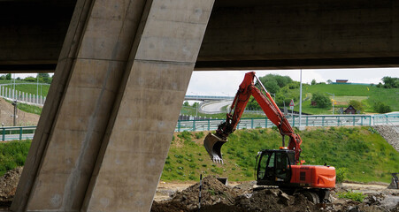 construction space, red-orange excavator, bulldozer or truck, mechanical car, bridge