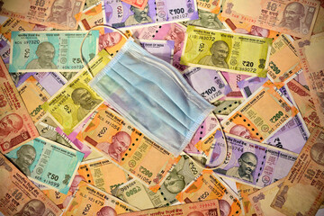 Protective face mask and Indian paper currency as a background