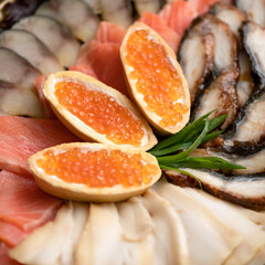 Three Sandwiches with red caviar at top appetizers of salmon and sturgeon fishes. Close up shot....