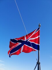 Huys-the fortress flag fluttering in the wind on the background of the blue sky. naval flag of russia fortresses.bow flag of warships 