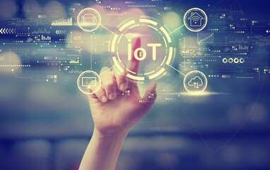 Fototapeta premium IoT theme with a hand pressing a button