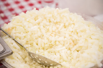 Shredded white cheese with spoon