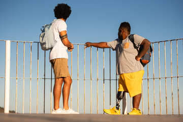disabled black man and friend looking at view.