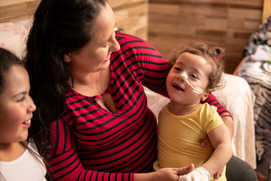 Disabled Child Smiling At Family.