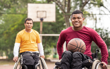 portrait of wheelchair men with basketball looking at camera..