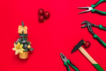 A set of quality green building tools to repair a car or house and Christmas tree on a red background. Do it yourself instruments. Banner for a New year advertise construction shop with copy space