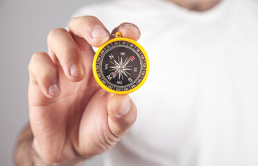 Caucasian male hand showing compass.