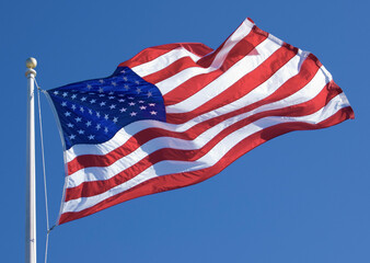 Waving American Flag Against Blue Sky