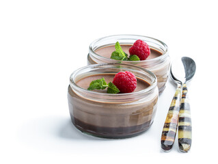 Mini caramel cheesecakes with raspberry in a glass pots isolated on white background