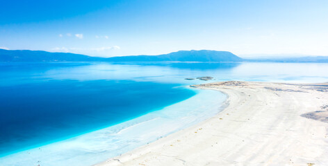 Aerial view over the clear beach and turquoise water of Salda lake. Burdur Province, Turkey