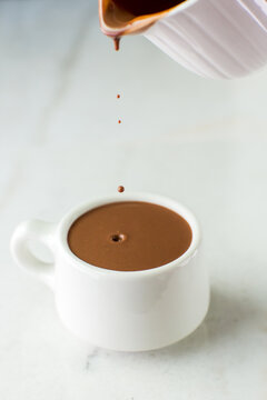 Sipping chocolate being poured into cup