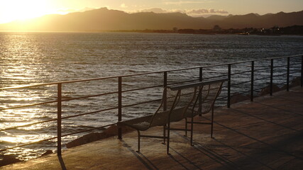 Fototapeta na wymiar empty bench by the sea at sunset