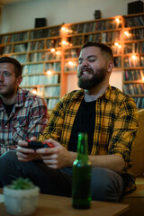 Two best friends playing video games while relaxing at home