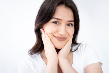 beautiful woman looking her skin at the mirror