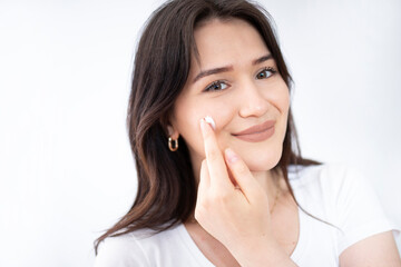 beautiful woman looking her skin at the mirror