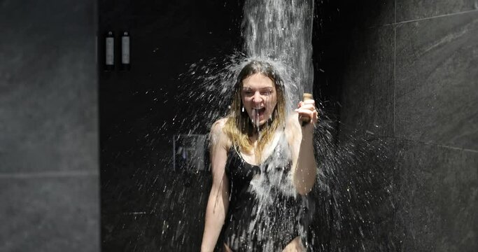 Woman hardening with bucket of ice cold water after hot sauna, healthy lifestyle and cold training concept. Wellness and spa.