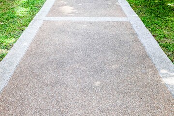 Long concrete walkway in the summer green garden