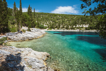 Beautiful Foki beach close to village of Fiskardo, is known for its emerald sea and cypress trees surrounding it. Ionian island Kefalonia, Greece.