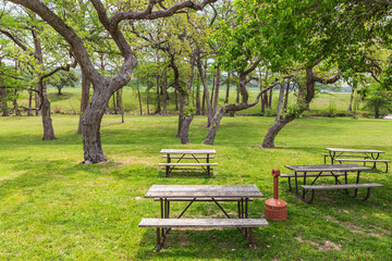 Picnic tables in a park in the Texas hill country.