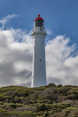 Fototapeta na wymiar Split Point Lighthouse (being painted) - Aireys Inlet, Great Ocean Road, Victoria, Australia