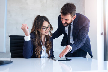 Millennial businesswoman talking with her coworker, speaking to her business partner. Female...