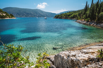 Beautiful Foki beach close to village of Fiskardo, is known for its emerald sea and cypress trees surrounding it. Ionian island Kefalonia, Greece.