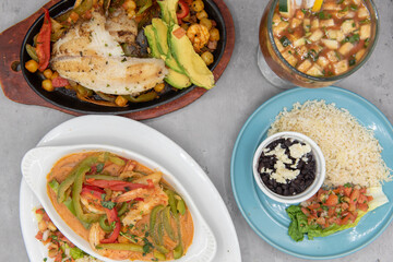 Mexican food feast with a variety of seafood fish, shrimp, and shellfish with rice and beans as sides with salsa