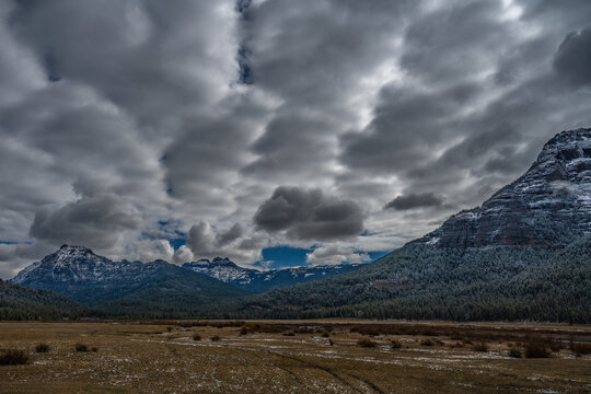 2021-05-10 SNOW CAPPED MOUNTAIN RANGE WITH STORM CLOUDS IN MONTANA