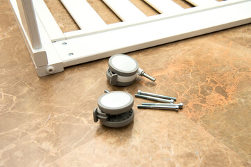 Parts to assemble a baby crib.