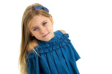 A blonde six to seven years old in a blue denim dress.