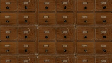 The camera pans up and down the rows of dilapidated catalog boxes. Seamless loop.