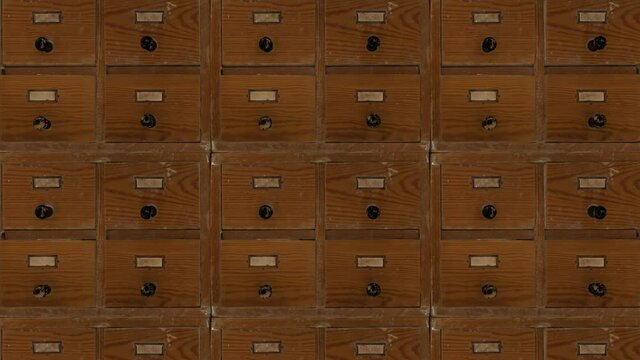 The camera pans up and down the rows of dilapidated catalog boxes. Seamless loop.